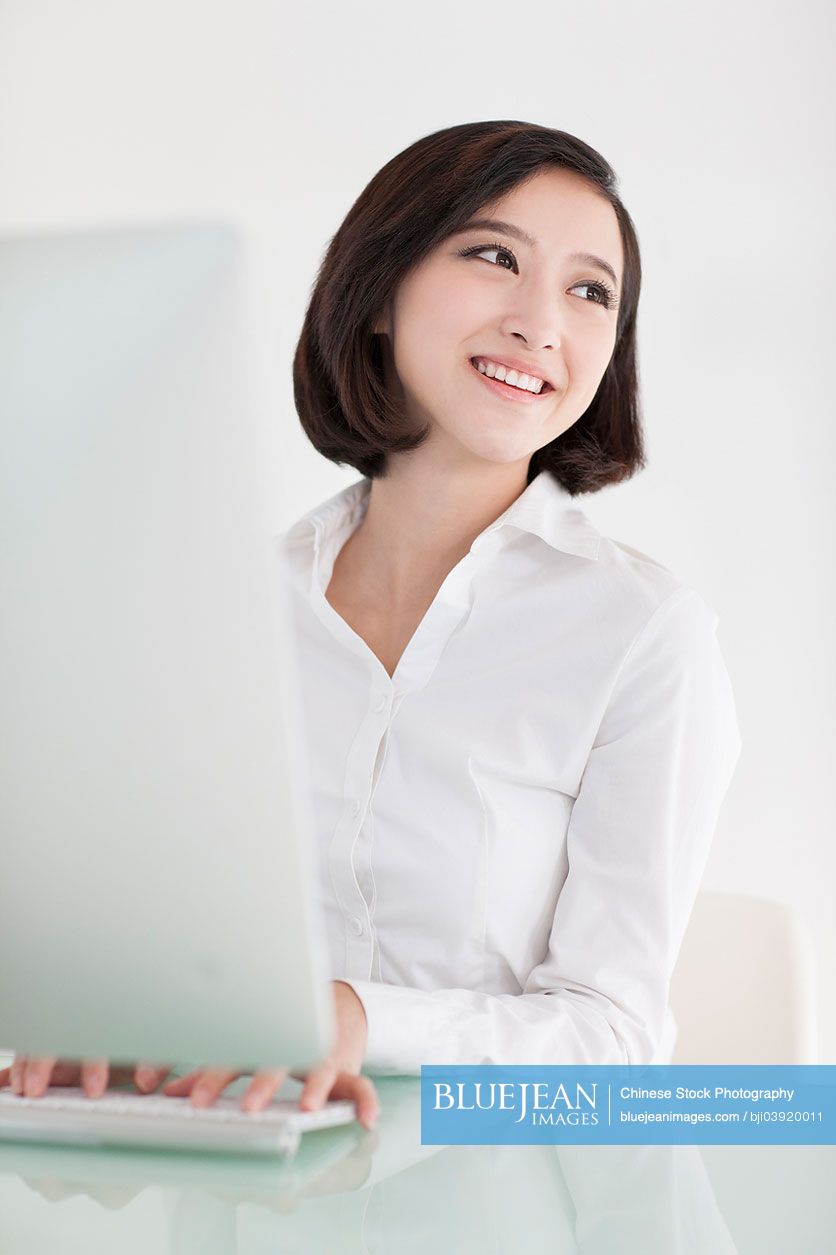 Young Chinese office lady at work