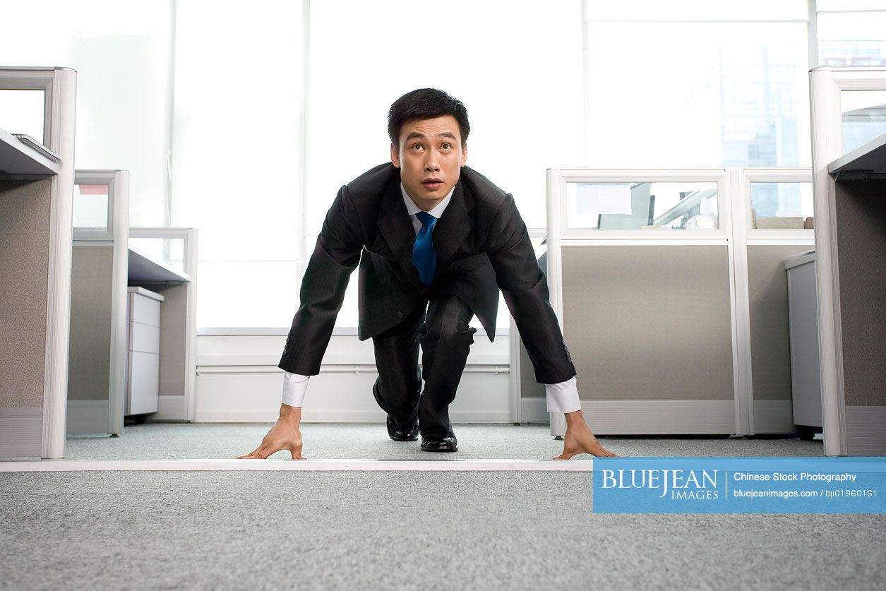 Chinese office worker ready to run in the office