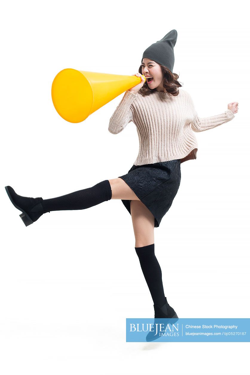 Young Chinese woman shouting through megaphone