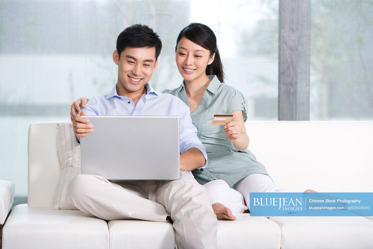 Portrait of  Chinese couple online shopping from home