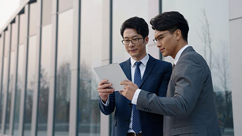 Confident Chinese business people talking outdoors