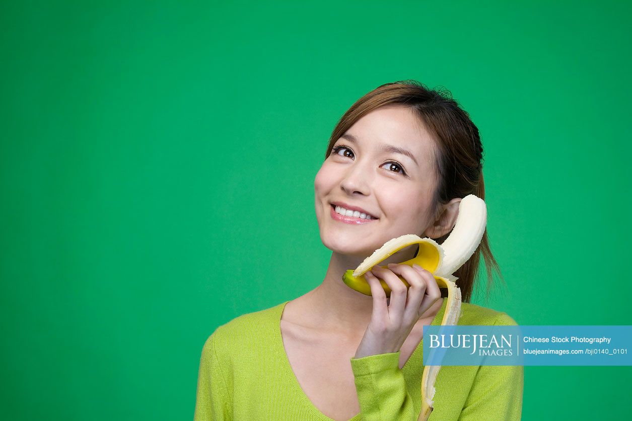 Chinese woman in green with a banana