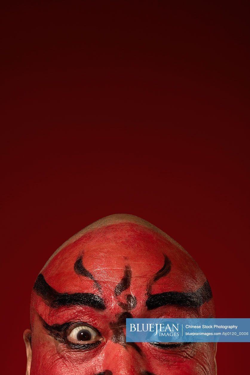 Chinese actor portraying Guang Dong, ancient Chinese general in  Beijing opera costume, represents protection and wealth