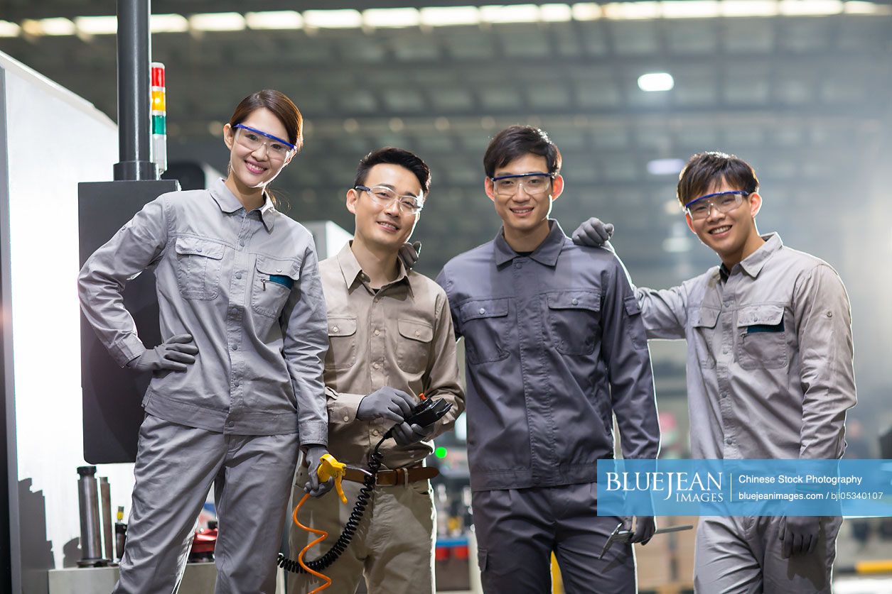 Confident Chinese engineering team in the factory