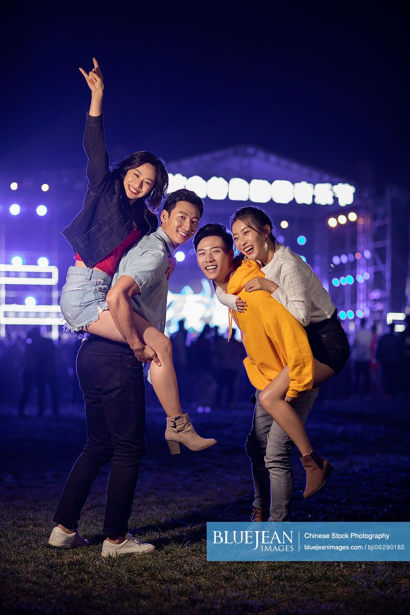 Happy young Chinese friends at music festival