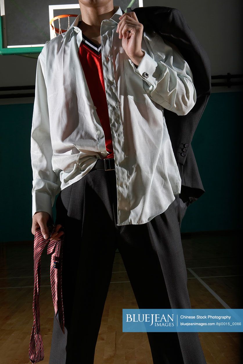 Disheveled Looking Chinese Businessman On Basketball Court